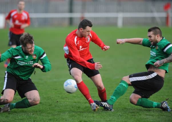 Sunderland RCA's Colin Larkin is outnumbered by two Sleaford defenders in their FA Vase clash