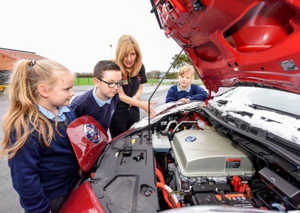 Karen Clare of the School Liason Team from Nissan, giving pupils a tour  of the Nissan Leaf at the school on Thursday. Pupils are l-r Talia Lumley, Ben Charlton and Trudy Johnson