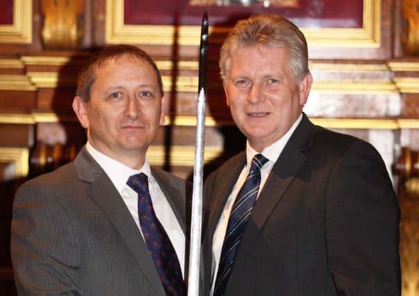 Metromail's Neil Buckett, left, being presented with the award by Michael  Robinson, Chief Executive of the British Safety Council.