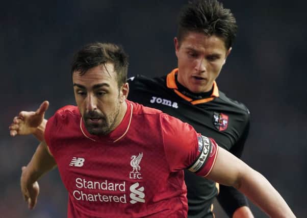 Tom Nichols (right) takes on Liverpool's Jose Enrique