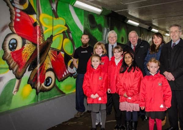 Local artist Frank Styles with members of the West Area Committee, Cllr Michael Essl (Barnes), Chair Cllr Peter Gibson, Cllr Rebecca Atkinson (Barnes),Cllr Ian Galbraith (Barnes) and children from Richard Avenue Primary School at the unveiling of the community arts project decorating the subway