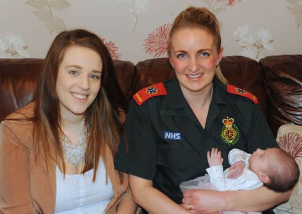 Paramedic Stacey Hilton with baby Gracie and her mum Devon Gaunt.