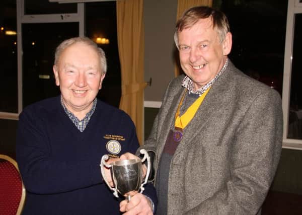 Winner of Houghton Rotary Club's Bill Curry Games was Alan Dickinson, left, who received the trophy from president elect Iain Anderson, right.