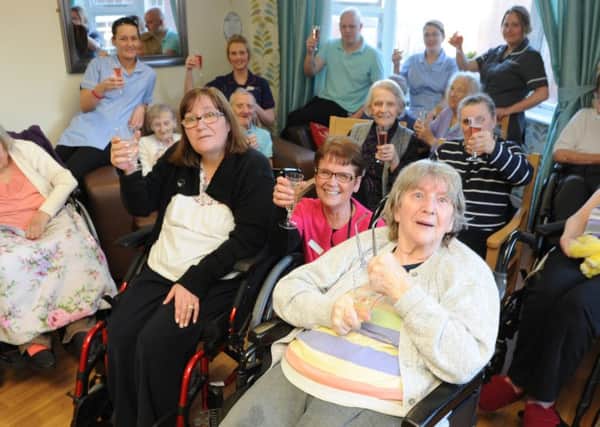 Barnes Court Care Home residents and staff celebrate their performance rating success.