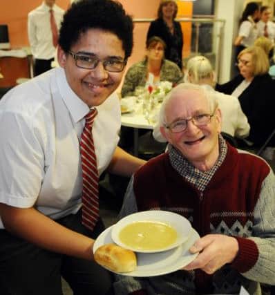 BrianGriffiths is served his soup by student David Collins (16) at the Over 60s Valentines meal held in Academy 360. Picture by FRANK REID