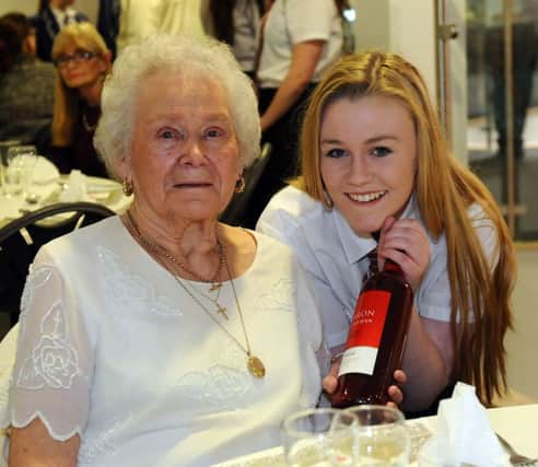Ethel Donkin (92) is served wine at the Over 60s Valentines meal held in Academy 360 by student Chloe Johnstone (16). Picture by FRANK REID