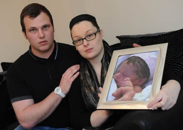 Jason Calvert and Jade Hutchinson with a photo of their tragic daughter Ava Marie.
