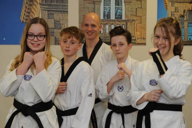 Bede Tigers Taekwondo club members Rebekah Lowes, Max Heskett, Jake Dutson, and Hannah Smith, who have all gained black belts, with lead coach Andy Lowes.