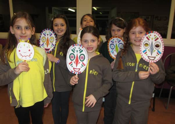St Nicholas Wednesday Brownies with their lion masks they made as part of their safari event.