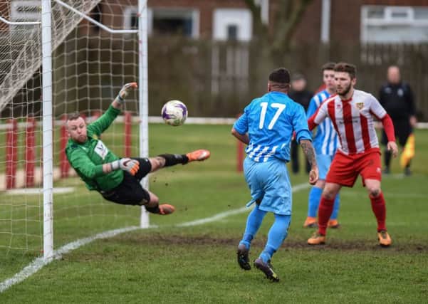 Crook Town keeper Ryan Graham makes a flying save against Ryhope CW on Saturday as home striker Conor Winter looms. Picture by Kevin Brady