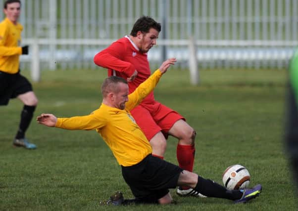 Murton (red) battle in vain against Sunderland West End. Picture by Tim Richardson