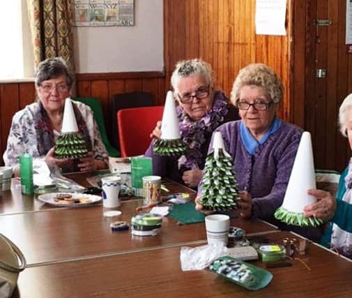 Members from the craft class, which meets in Middle Herrington Methodist Church, making Christmas trees.