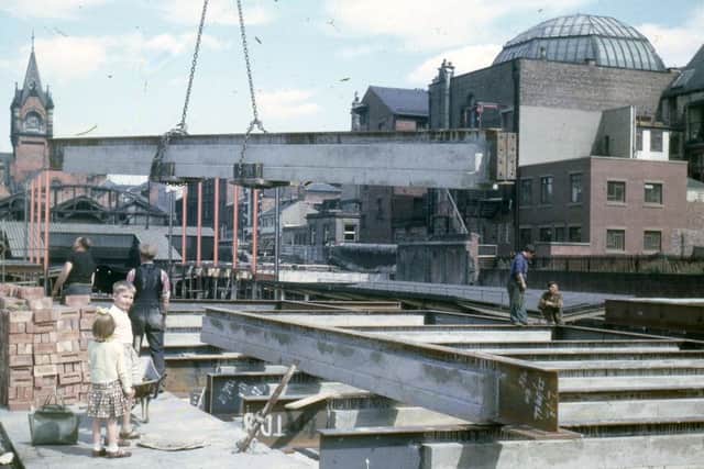 The dome of La Strada can just be seen over the metal girder being lowered into place during a revamp of Sunderland Station in the 1960s.