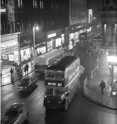 A bus just passing the Gaumont Cinema and Maynards.