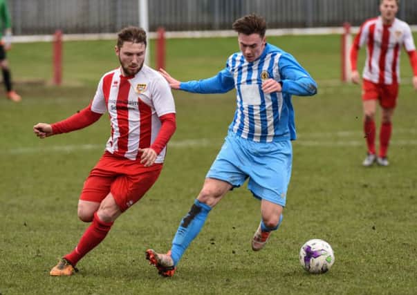 Ryhope CW striker Conor Winter (left) takes on Crook Town in last week's 5-1 victory. Picture by Kevin Brady