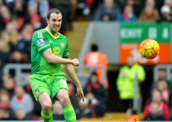 Sunderland skipper John O'Shea in the green away shirt which will be given away free to travelling fans on Saturday