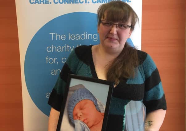 Traceyanne Healer with the Diabetes UK award, clutching a photo of Nathan.
