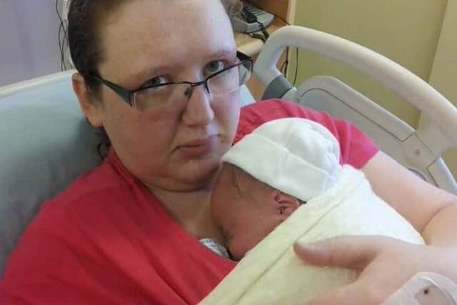 Traceyanne Healer cradles her precious son, Nathan, just after his birth.
