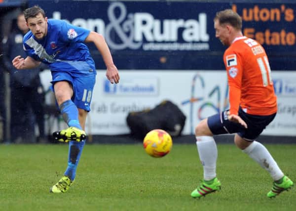 Pools' Lewis Hawkins (left) sends over a cross in last week's defeat at Luton. Picture by Frank Reid