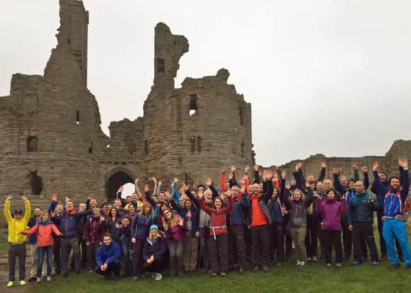 Berghaus staff celebrate at Dunstanburgh Castle in Northumberland.