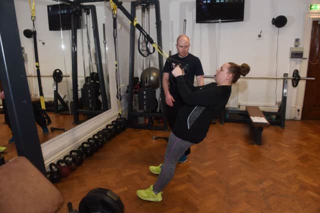 Fitness coach Tim Ford putting Echo competition winner Alexandra Reay thrugh her paces at The Fitness Bank