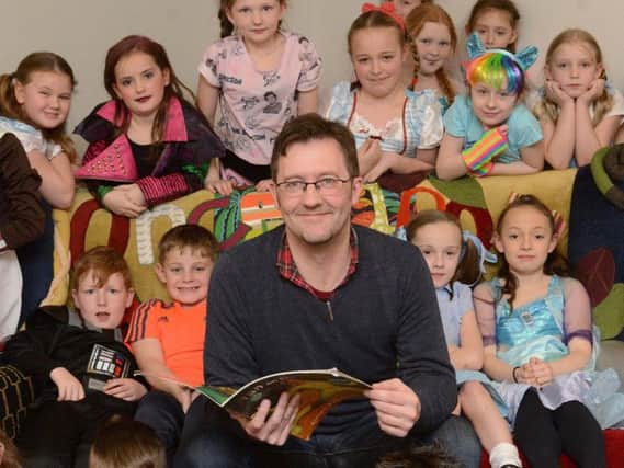children's author Simon Bartram with youngsters.