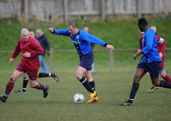 Washington Sandpiper (blue) and Easington CIU battle in the Over-40s' Alan Spedding Cup tie last week. Picture by Tim Richardson