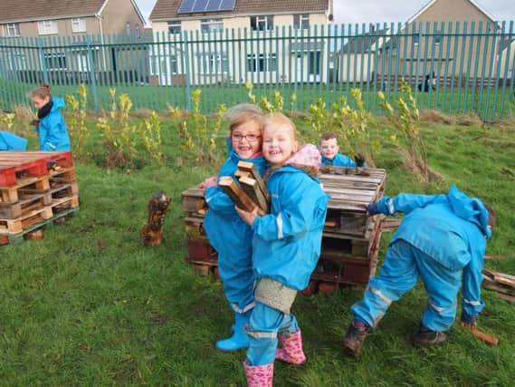 Pupils from George Washington Primary School making a bee 'hotel' to attract bees and other important pollinators.