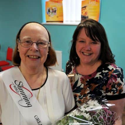 Margaret Ede is presented with flowers by group leader Joanne Thirlwell.