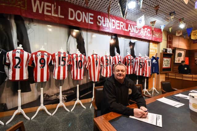 Michael Ganley with some of the shirts featured in the display of memorabilia.