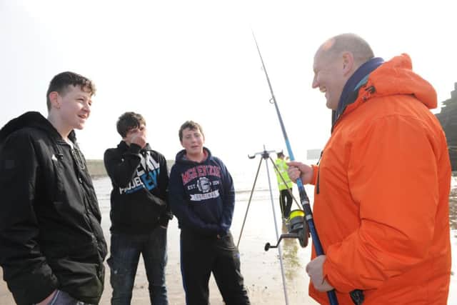 Durham's Chief Constable Mike Barton with youngsters James Howe, Ryan Graydon and Liam Miller fishing at Seaham Marina.