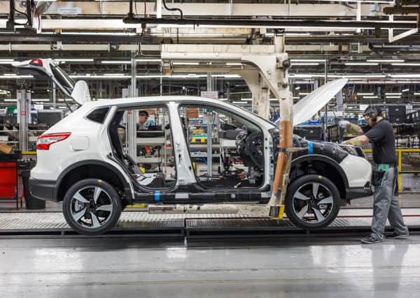 A worker puts the finishing touches to a Qashqai at Sunderland.