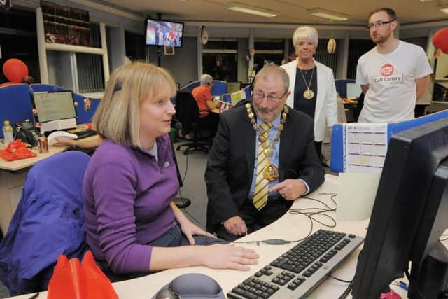 Sunderland Deputy Mayor Alan Emerson gives support to council staff volunteers who are taking phone donations for Sport relief.