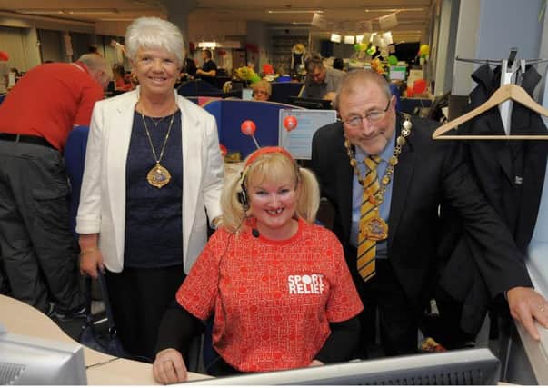 Sunderland Deputy Mayor Alan Emerson and  Mayoress Janice Emerson give support to council staff volunteers who are taking phone donations for Sport relief. with Margaret Kennedy answering the phones.