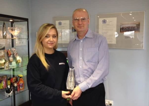 Megan Ford receives her award from Rayovac's Paul Deeble