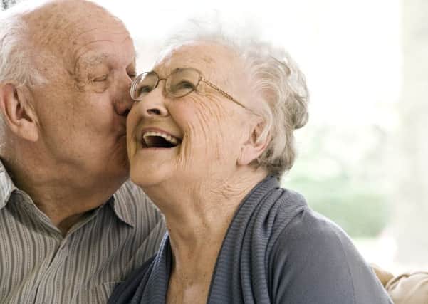 An elderly couple sharing a tender moment.