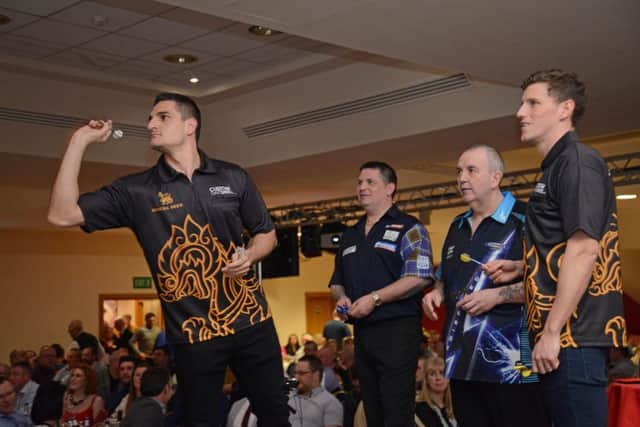 Vito Mannone takes aim under the watchful eye of Gary Anderson, Phil Taylor and Billy Jones.