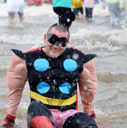 Stephen Taylorson sitting in the The North Sea as he takes part in the Sunderland Boxing Day dip held at Seaburn beach.