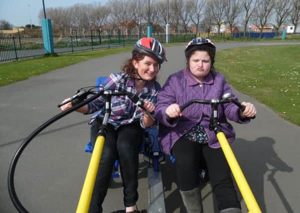 A support worker and a member of the society use one of the go-kart bikes before they were stolen.