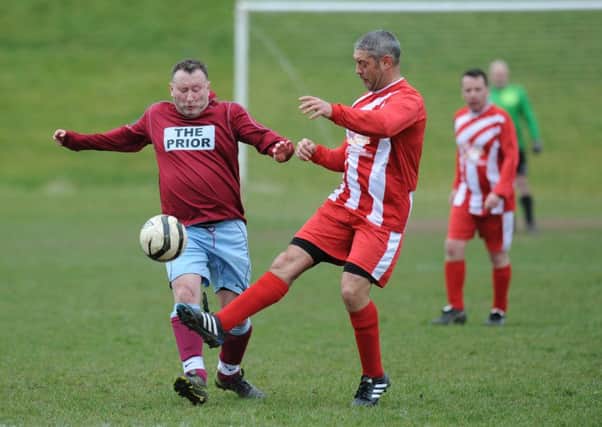 Oddfellows Arms (red white) battle Colonel Prior in the Over-40s League.