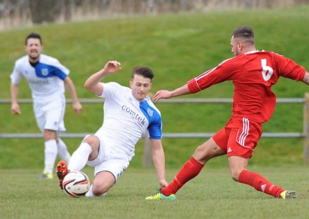 Washington's Chris Wallace (red) battles for the ball against Bishop Auckland last week. Picture by Tim Richardson