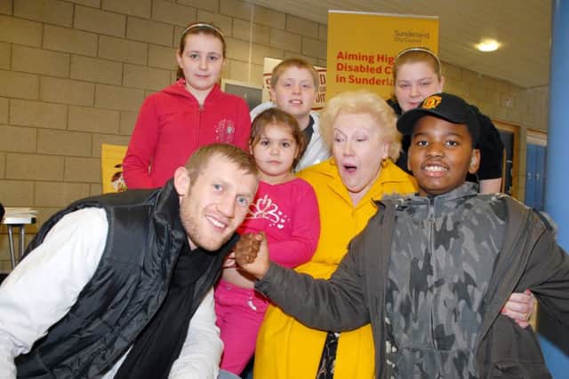 KNOCKOUT......DENISE ROBERTSON JOINS IN THE FUN AS CHILDREN TRY A PLAYFUL PUNCH ON THE CHEEK OF TONY JEFFRIES AT AN ACIVITY EVENT FOR DEAF CHILDREN AT THE RAICH CARTER CENTRE.