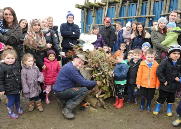 Sculptor Neil Canavan with parents and pupils at Newbottle Primary Academy in the Forest School.