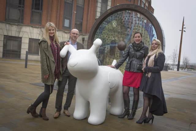Retail Liaison Manager John Green and Marketing Manager Samantha Czwordon-Wright from The Bridges with one of the giant snow dogs during its visit to Sunderland Picture: DAVID WOOD