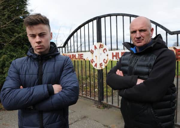 Charlie Hurley's grandson Matt Titchen at the gates to Sunderland Football Club's former training ground The Charlie Hurley Centre, Whitburn, with campaigner Peter Curtis.