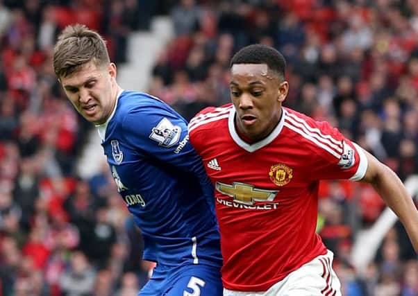 John Stones, with Manchester United's Anthony Martial