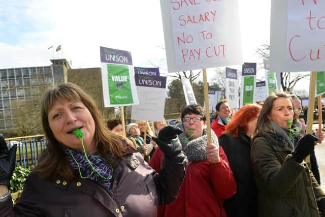 Teaching assistants protest at Durham's County Hall over proposed pay changes.
