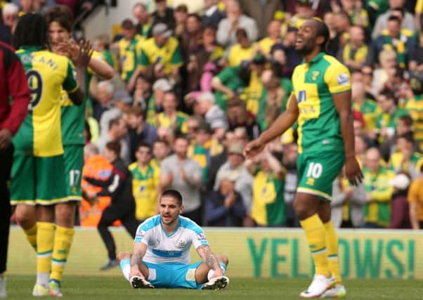 Newcastle United's Aleksandar Mitrovic (centre) sits dejected on the pitch after the final whistle of their defeat at Norwich