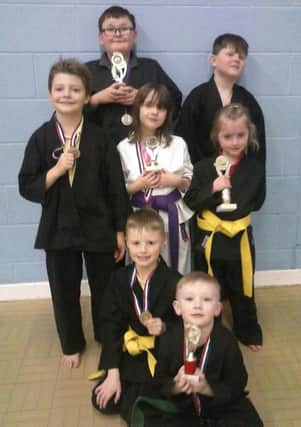 Members of Doxford Park Karate Club with the trophies and medals gained at recent NKA competition.