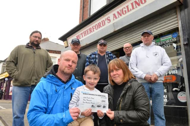 Rutherfords Angling donate funds to Washington youngster Derek Russell. Mother and father Michelle and Derek Russell.
